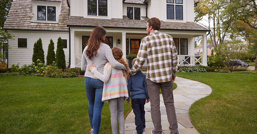 Family Outside Front Of Home