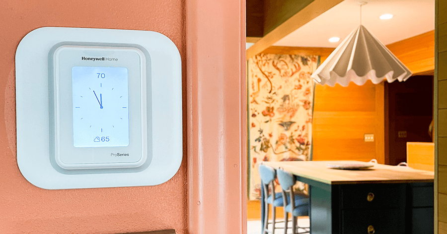 A Honeywell Home smart thermostat on the wall. 