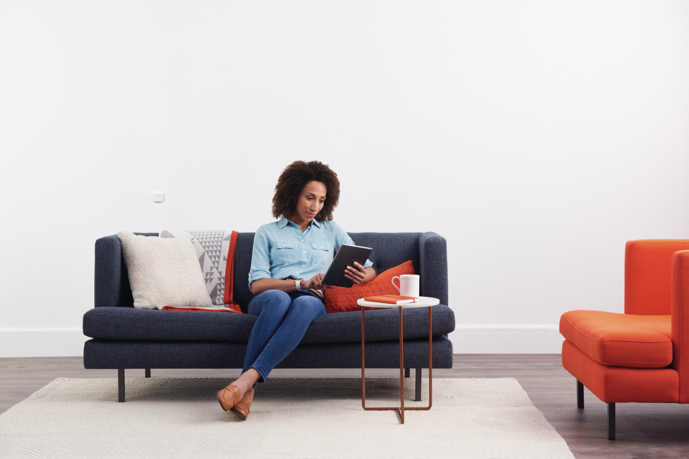 Woman using tablet on a sofa