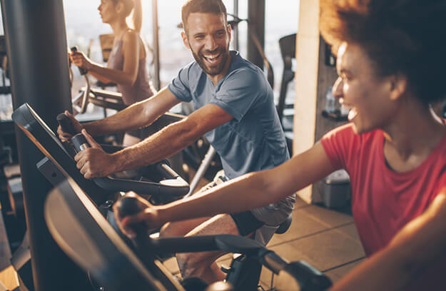 People in a gym using cardio machines