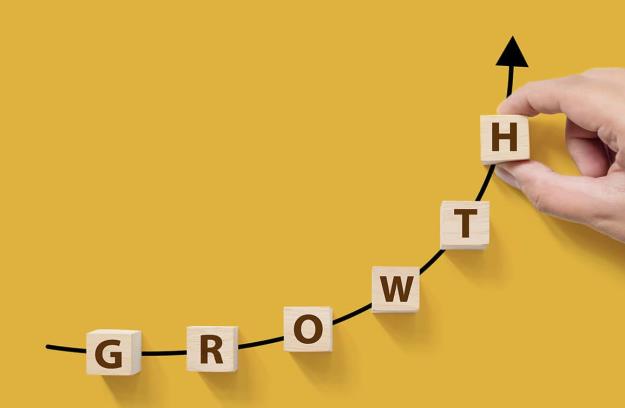 Letter blocks in an upward curve that reads growth