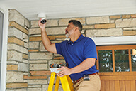 Pro installer is installing the out door camera lo  res.