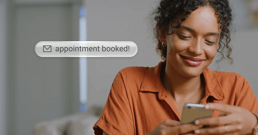 A woman is schedule a professional  Pro-IQ™ installation appointment on her phone