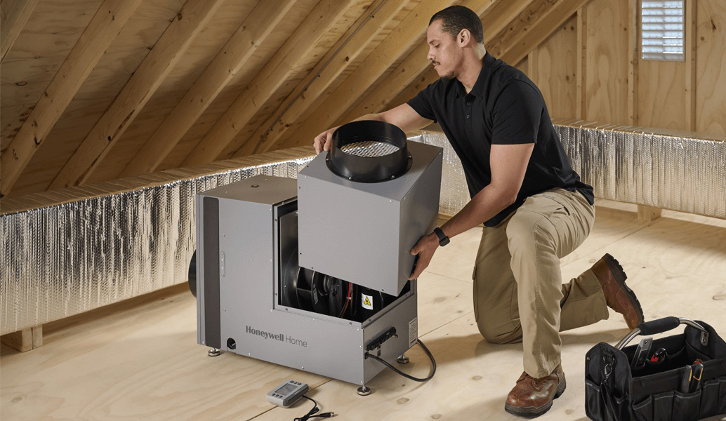 A pro installs a whole home dehumidifier.